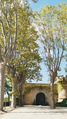 Arenys de munt, Barcelona,Spain;25 Septembre 2022: Green trees around the sand road. Entrance to Jalpi castle.