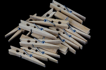 Pile of Wooden Clothes Pegs on a Black Surface