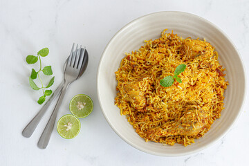 Indian Chicken Biryani in a Bowl with Yogurt, Mint, Lemon Top Down Photo