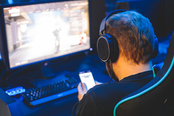 Cyber sport e-sports tournament, team of professional gamers, gamer's hands on mouse and keyboard, pushing button, gamers playing in competitive moba, strategy fps game in a cyber games arena club