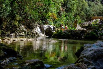 Naklejka na ściany i meble hikers bathing in the river, God's Bridge, Akchour, Talassemtane Nature Park, Rif region, morocco, africa