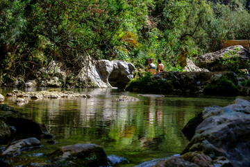 hikers bathing in the river, God's Bridge, Akchour, Talassemtane Nature Park, Rif region, morocco, africa