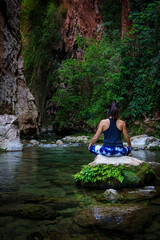 woman practicing yoga by the river, God's Bridge, Akchour, Talassemtane Nature Park, Rif region, morocco, africa