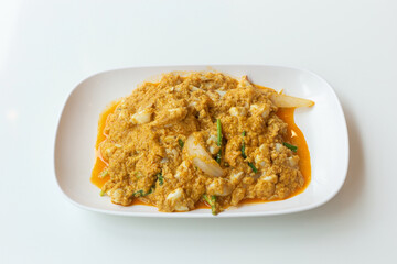 Stir fried crab meat with curry delicious seafood in a white plate.