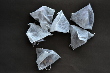 Tea bags lie on a black background