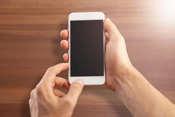 Human hand hold a smartphone with blank screen