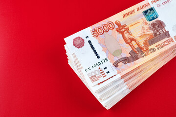 Russian rubles five thousandth banknotes, stack of money on red background