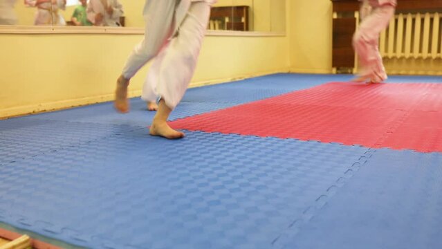 Children are warming up their legs before demonstration of karate. Healthy lifestyle concept, playing sports. Martial arts. Judo, Jiu Jitsu. Bold, strong. does a warm-up, workouts