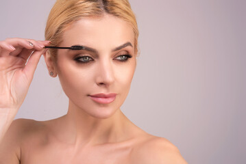 Perfect eyebrows. Natural beauty brows. Eyebrows coloring and lamination. Woman combing eyebrows....