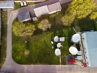 Satellite communication node of a telecom operator from a height. View of large satellite dishes...