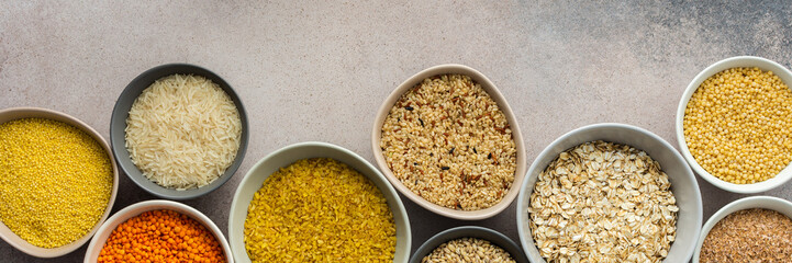 Various grain cereals in bowls banner, top view