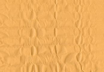 Yellow wrapping paper with dents and chaotic folds texture
