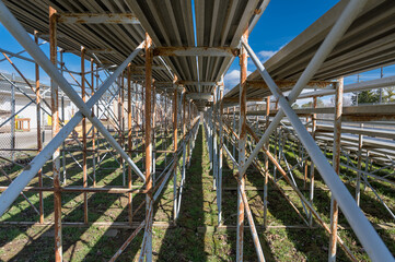 Underside of bleachers showcasing the beams, supports, and bracing elements that hold the bleachers together