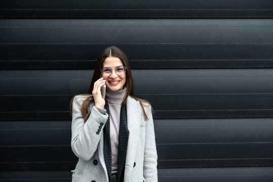 Portrait of a young successful businesswoman, sales manager, boss and foreman standing in front of an office building. Business person leader and expert in global business and telecommunications