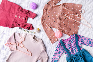 Baby girl clothes with pacifier and toys