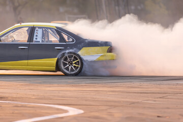 Drift car burning tires on speed track. © toa555
