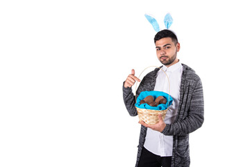 Fototapeta premium Young attractive student dressed as a rabbit on Easter holiday. Happy man. 