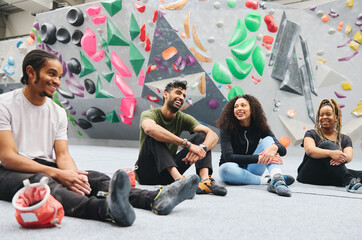 Group Of Friends Waiting To Try Climbing Wall At Indoor Centre