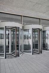 Fototapeta Revolving doors. The facade of a modern shopping center or station, an airport with revolving doors. obraz