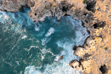 drone view of sea splashing on cliffs rocks and caves in Sagres in Algarve Portugal 