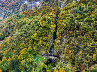 Autumn on the Karst waterfall of Fontanon di Goriuda. View from above.