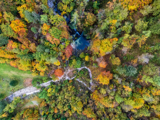 Autumn on the Karst waterfall of Fontanon di Goriuda. View from above.