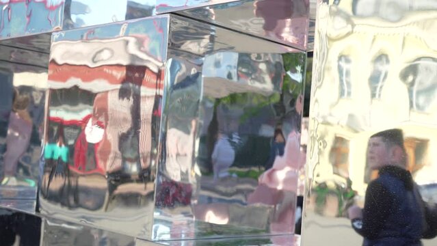 Mirror sculpture that reflects everything around. The concept of purity and transparency. Mirror, glass, reflection.