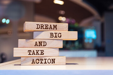 Wooden blocks with words 'Dream big and take action'. Inspirational motivational quote