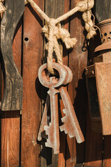 A bunch of old wooden keys hanging on a rope, close-up