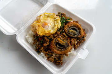 
Stir Fried Basil with Spicy Century Egg Served with steamed rice and chili fish sauce, Thai food.