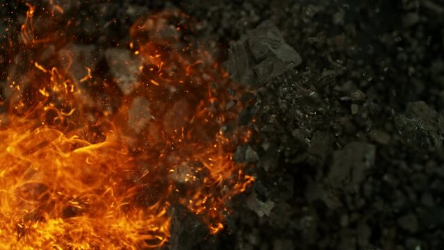Super slow motion of rotating coal pieces with fire. Filmed on high speed cinema camera, 1000fps. Concept of fossil fuel burning and global warming problem.