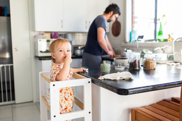 Morning time routine getting breakfast ready - baby at bench with dad doing dishes