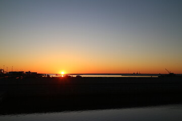 Sunset over the sea coast in the city