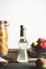 Bottle of apple cider vinegar on white background