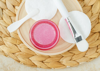 Pink glass jar with rose jelly hydrating bubble mask, face moisturizer. Natural skin care concept....