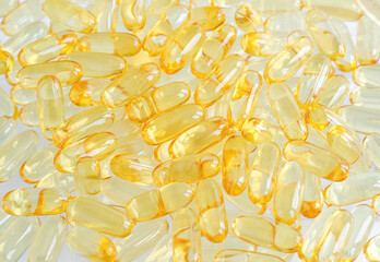 Cod-liver oil (vitamin D, E, A, cosmetic serum) supplement softgel capsules. Close-up, selective...