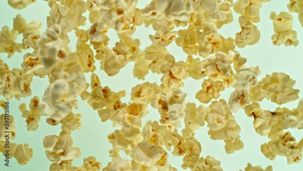 Poster super slow motion of rotating popcorn in the air. isolated on colored background. filmed on high spe