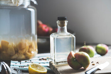 Bottle of apple cider vinegar on rustic background