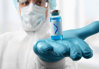 Lab scientist holding bottle vial and DNA strand