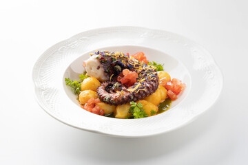 octopus with boiled potatoes and vegetables on a white background