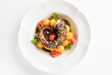 octopus with boiled potatoes and vegetables on a white background