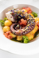 octopus with boiled potatoes and vegetables on a white background