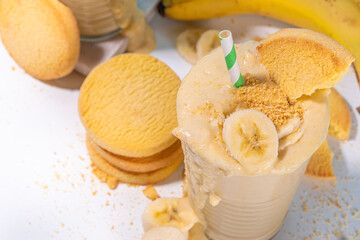 Fototapeta na wymiar Banana biscuit smoothie. Sweet milk shake with fresh bananas and vanilla shortbread cookies 
