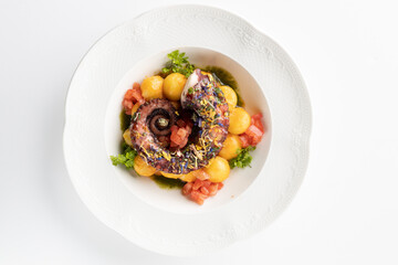 octopus with boiled potatoes and vegetables on a white background