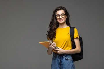 Young happy student with backpack isolated on white bacoground