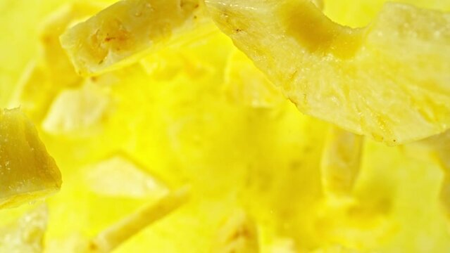 Super slow motion of rotating pineapple slices, top view. Filmed on high speed cinema camera, 1000 fps, placed on high speed cine bot, following the target. Speed ramp effect.