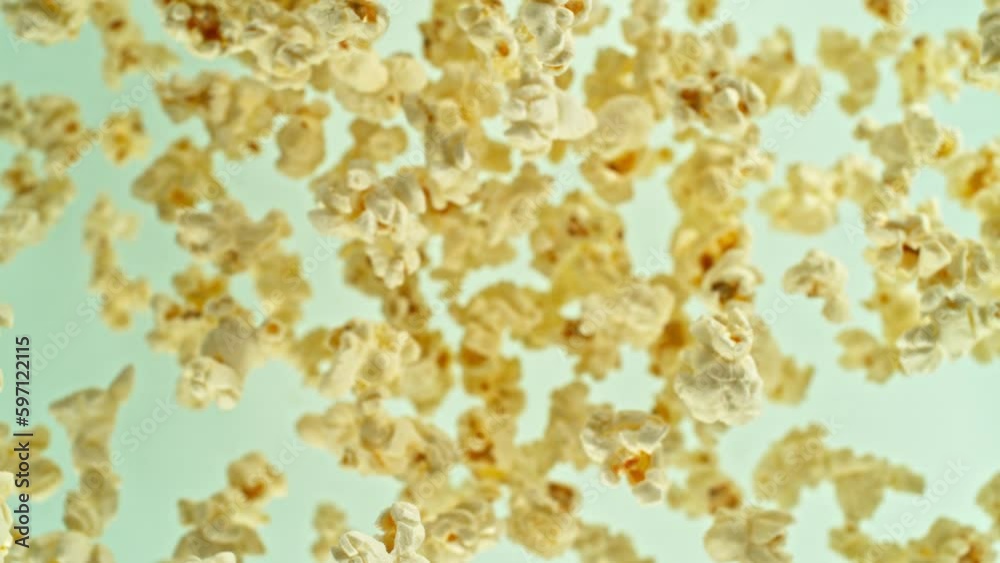 Poster super slow motion of rotating popcorn in the air. isolated on colored background. filmed on high spe