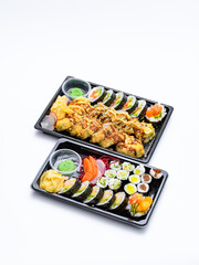 Dwa zestawy sushi na białym tle - obrazy, fototapety, plakaty