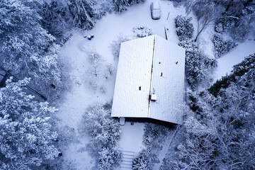Top down photo of the snow covered roof and trees in a garden in Germany
