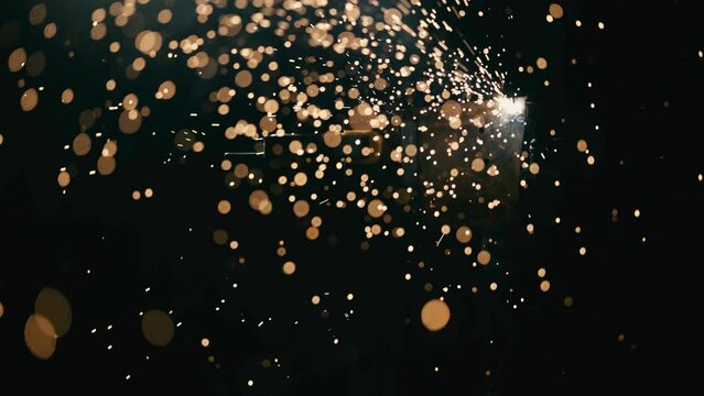 Slow motion: laser cutting, working with a metal workpiece with sparks in a factory. Metalworking, machining, industry, equipment, technology, production concept